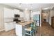 Contemporary kitchen featuring granite counters, white cabinets, and stainless steel appliances, adjacent to hallway at 11231 Woodlake Way, Parrish, FL 34219