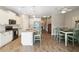 Bright kitchen area showcasing an island, stainless steel appliances, and open access to the dining area at 11231 Woodlake Way, Parrish, FL 34219
