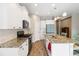 Bright kitchen features granite countertops, stainless steel appliances, and white cabinetry at 11231 Woodlake Way, Parrish, FL 34219