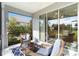 Charming screened lanai with wicker furniture, ceiling fan, and sliding glass doors to the interior at 11231 Woodlake Way, Parrish, FL 34219