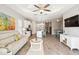 Spacious living area featuring an open layout, modern decor, and wood-look tile flooring at 11231 Woodlake Way, Parrish, FL 34219