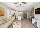 Open-concept living area seamlessly connects kitchen, living, and dining spaces with sleek floors at 11231 Woodlake Way, Parrish, FL 34219
