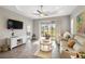 Inviting living room showcasing neutral tones, stylish decor, and access to a serene screened-in patio at 11231 Woodlake Way, Parrish, FL 34219