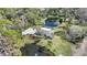 Aerial view of property featuring a home, pool, large driveway and a pond with a fountain at 1521 67Th Street E Ct, Bradenton, FL 34208