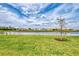 Scenic backyard view showcasing a tranquil pond and newly constructed homes in the community at 16119 Fortezza Dr, Bradenton, FL 34211
