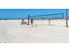 Beautiful sandy beach scene with volleyball net, perfect for recreational activities and relaxation at 16119 Fortezza Dr, Bradenton, FL 34211