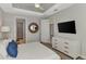 Well-lit bedroom featuring a ceiling fan, TV, connected bathroom, walk in closet, and comfortable rattan bed at 16119 Fortezza Dr, Bradenton, FL 34211