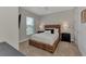 Inviting bedroom featuring a comfortable bed, stylish nightstands, lamps, and a large window for natural light at 16119 Fortezza Dr, Bradenton, FL 34211