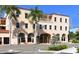 Elegant building with distinct architecture, featuring arched windows and lush landscaping at 16119 Fortezza Dr, Bradenton, FL 34211