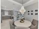 Elegant dining area with a chandelier, table with seating, open to a modern kitchen with stainless steel appliances at 16119 Fortezza Dr, Bradenton, FL 34211