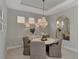 Dining room featuring a tray ceiling and hanging chandelier at 16119 Fortezza Dr, Bradenton, FL 34211