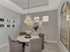 Elegant dining room showcases tray ceiling and stunning chandelier at 16119 Fortezza Dr, Bradenton, FL 34211