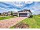 Single Gathering home with a two car garage, paver driveway, green grass and professionally landscaped front yard at 16119 Fortezza Dr, Bradenton, FL 34211