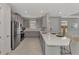 Well-lit kitchen featuring stainless steel appliances, gray cabinets, and a center island with seating at 16119 Fortezza Dr, Bradenton, FL 34211