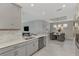 Bright kitchen boasts stainless appliances and opens to the dining area with elegant chandelier at 16119 Fortezza Dr, Bradenton, FL 34211