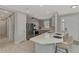 Bright kitchen features stainless steel appliances, gray cabinets, and a large center island with counter seating at 16119 Fortezza Dr, Bradenton, FL 34211