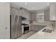 Well-equipped kitchen features stainless steel appliances, gray cabinets, and ample counter space at 16119 Fortezza Dr, Bradenton, FL 34211