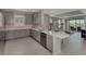 Open kitchen with gray cabinets, stainless appliances, and a view into the bright, spacious living area at 16119 Fortezza Dr, Bradenton, FL 34211