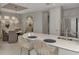 Kitchen island with bar seating featuring gray cabinets, stainless steel appliances, and open to the dining area at 16119 Fortezza Dr, Bradenton, FL 34211