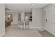 Open concept kitchen with stainless steel appliances, gray cabinets, and counter seating at the island at 16119 Fortezza Dr, Bradenton, FL 34211