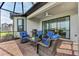 Stylish lanai featuring comfortable seating and a modern grill, ideal for outdoor enjoyment at 16119 Fortezza Dr, Bradenton, FL 34211