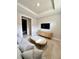 Cozy living room with a plush sofa, modern media center, and tiled floors at 16119 Fortezza Dr, Bradenton, FL 34211