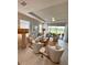 Bright living room features neutral decor, tile floors, high ceilings, lots of natural light, and sliding glass doors to a patio at 16119 Fortezza Dr, Bradenton, FL 34211