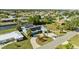 Aerial shot of a home with solar panels, an extended lanai, a private canal, and lush landscaping in a charming neighborhood at 198 Salem Nw Ave, Port Charlotte, FL 33952