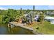 This aerial view shows the property's private boat lift, metal roof, solar panels, lanai and lush landscaping at 198 Salem Nw Ave, Port Charlotte, FL 33952