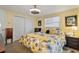 Inviting bedroom with a queen bed, ceiling fan, closet, and a floral comforter at 198 Salem Nw Ave, Port Charlotte, FL 33952