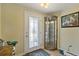 Bright entryway with decorative glass door, tile floors, and display cabinet, creating a welcoming ambiance at 198 Salem Nw Ave, Port Charlotte, FL 33952