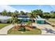 Charming single-story home with a circular driveway, well-maintained landscaping, and solar panels at 198 Salem Nw Ave, Port Charlotte, FL 33952