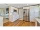 Modern kitchen with white cabinets, stainless steel refrigerator, and hardwood flooring at 198 Salem Nw Ave, Port Charlotte, FL 33952