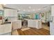 Bright kitchen featuring white cabinets, stainless steel appliances, and hardwood flooring at 198 Salem Nw Ave, Port Charlotte, FL 33952