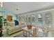 Bright living room with a view of the pool through glass doors, and comfortable seating at 198 Salem Nw Ave, Port Charlotte, FL 33952