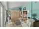Inviting living room featuring light blue walls, comfortable seating, and built-in storage at 198 Salem Nw Ave, Port Charlotte, FL 33952