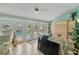 Sunroom features tiled floors, bright blue walls, seating, and access to the outdoor pool at 198 Salem Nw Ave, Port Charlotte, FL 33952