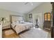 Bright main bedroom with high ceilings, light-colored walls, and a sliding glass door for outdoor access at 198 Salem Nw Ave, Port Charlotte, FL 33952