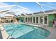 Stunning screened-in pool area with outdoor kitchen and ample lounging space at 198 Salem Nw Ave, Port Charlotte, FL 33952