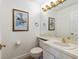 Half bath features a pedestal sink, mirror, and white toilet at 2630 Moss Oak Dr # 50, Sarasota, FL 34231