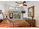 Comfortable primary bedroom showcases view to the outdoors, ceiling fan, and king bed at 2630 Moss Oak Dr # 50, Sarasota, FL 34231