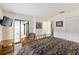 Bright secondary bedroom features hardwood floors, closet and view to the outdoors at 2630 Moss Oak Dr # 50, Sarasota, FL 34231