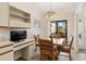 Cozy dining area with a table and chairs, built-in shelving, and natural light from the sliding glass door at 2630 Moss Oak Dr # 50, Sarasota, FL 34231