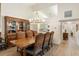 Elegant dining room featuring a wooden table, upholstered chairs, and a decorative chandelier at 2630 Moss Oak Dr # 50, Sarasota, FL 34231