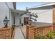 Inviting entrance with brick pillars, elegant lighting fixtures, and a well-maintained walkway at 2630 Moss Oak Dr # 50, Sarasota, FL 34231