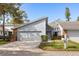 Charming home featuring a two-car garage, light-blue siding, brick accents, and well-manicured landscaping at 2630 Moss Oak Dr # 50, Sarasota, FL 34231