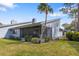 Exterior view of the home showing the screened-in patio and mature landscaping at 2630 Moss Oak Dr # 50, Sarasota, FL 34231