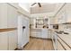 Bright kitchen features modern white appliances, wooden accents, and light wood flooring at 2630 Moss Oak Dr # 50, Sarasota, FL 34231
