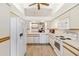 Bright kitchen featuring white cabinetry, modern appliances, and a functional layout at 2630 Moss Oak Dr # 50, Sarasota, FL 34231