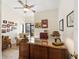 Bright office features a large desk, sitting area, and view to outdoor patio at 2630 Moss Oak Dr # 50, Sarasota, FL 34231